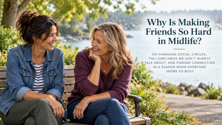 Two women in their fifties, one wearing a denim jacket and the other a plum sweater, laugh together on a wooden bench beside a lake. The header includes the title “Why Is Making Friends So Hard in Midlife?” and its subtitle about loneliness and finding connection.