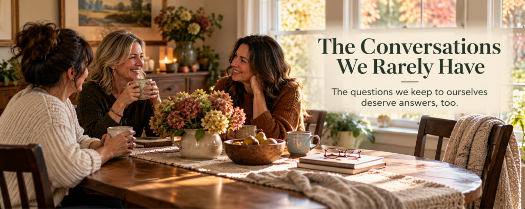 Three women enjoying a relaxed conversation around a wooden dining table in a sunlit autumn room, with an empty chair welcoming someone to join them. Text reads “The Conversations We Rarely Have” and “The questions we keep to ourselves deserve answers, too.”