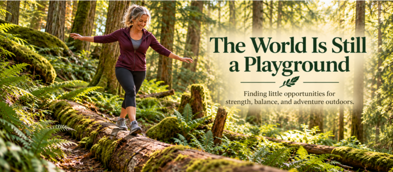A smiling, gray-haired woman balances along a fallen log in a sunlit forest surrounded by moss-covered trees, ferns, and woodland greenery.